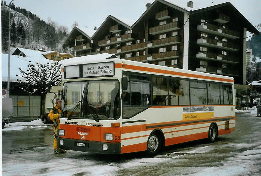 (083'132) - MOB Montreux - Nr. 26/BE 131'388 - MAN (ex BSF Hochdorf) am 19. Februar 2006 beim Bahnhof Gstaad